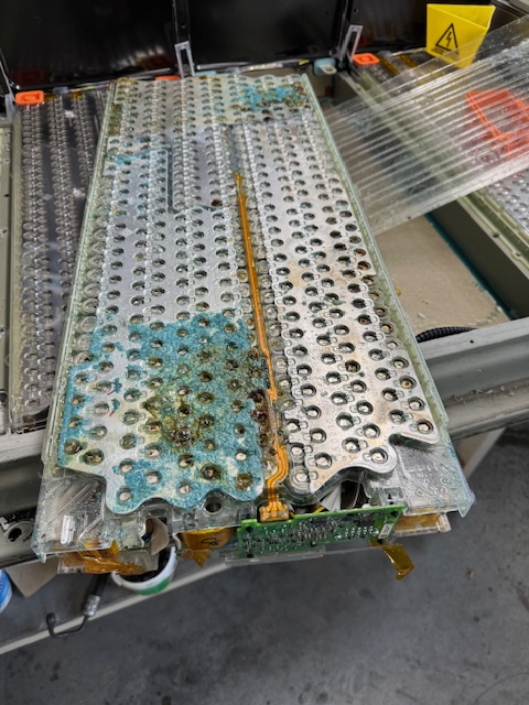 Tesla battery module with corrosion damage